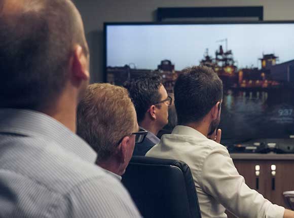  Office workers in meeting with presentation